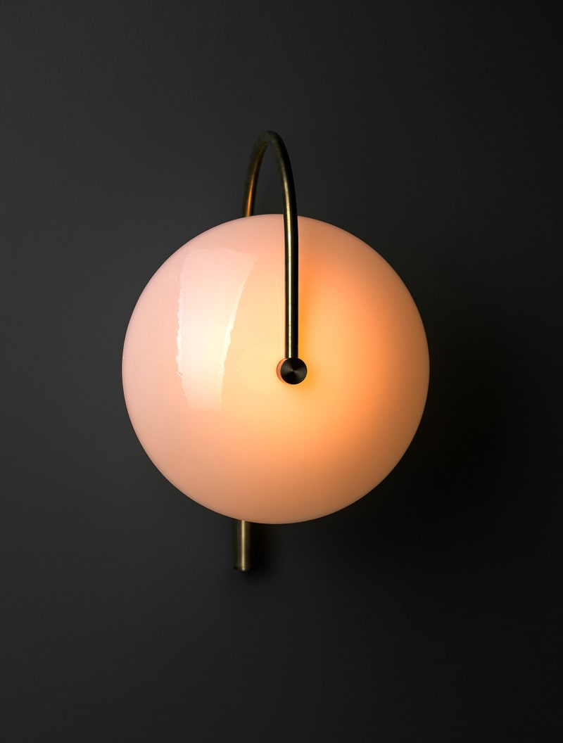 Aperture Sconce shown in Raw Brass, Opal Dome